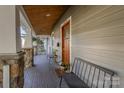 Inviting front porch with stone pillars and wooden flooring at 1619 Scott Ave, Charlotte, NC 28203