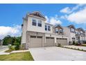 Two-story townhome with two-car garage and stone accents at 14917 Tamarack Dr, Charlotte, NC 28278