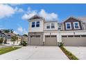 Two-story townhome with two-car garage and stone accents at 14917 Tamarack Dr, Charlotte, NC 28278