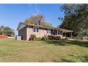 Side view of brick ranch house, showcasing yard and landscaping at 961 Shallowbrook Dr, Chester, SC 29706