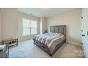 Spacious bedroom with large window and built-in drawers at 5014 Painswick Pl, Charlotte, NC 28215