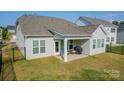 Covered patio with fenced backyard and grill at 5014 Painswick Pl, Charlotte, NC 28215