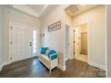Bright entryway with bench, coat hooks, and access to a half bath at 5014 Painswick Pl, Charlotte, NC 28215