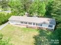 Single-story home with attached garage and large backyard at 1668 Lane Rd, Mount Holly, NC 28120