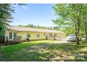 Back of house with deck, ramp, and large yard space at 1668 Lane Rd, Mount Holly, NC 28120
