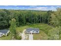 Single-story house on a wooded lot with a gravel driveway at 253 Artemis Pl, Kershaw, SC 29067