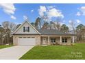 Inviting two-story home with brick and siding exterior and front yard at 5311 Carden Dr, Charlotte, NC 28227