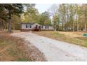 Single-wide mobile home with a gravel driveway at 2353 S Springhill Ct, York, SC 29745