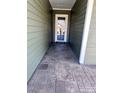 Side entrance with stamped concrete walkway leading to the front door at 131 Chimney Rock Ct, Denver, NC 28037