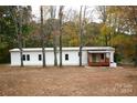 White mobile home with wooden porch at 2869 9Th Se Ave, Hickory, NC 28602