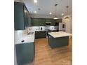 Modern kitchen with dark green cabinets, quartz countertops, and island at 320 Lawrence Gray Rd, Charlotte, NC 28262