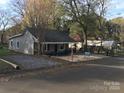 Updated bungalow with gray siding, new front porch and gravel driveway at 605 N Mcfarland N St, Gastonia, NC 28054