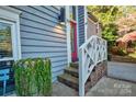 Front entrance with red door, brick steps, and white railing at 94 Heritage Dr, Lake Wylie, SC 29710