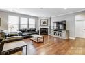 Living room with hardwood floors and a corner fireplace at 7006 Garden Hill Dr, Huntersville, NC 28078