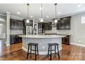 Modern kitchen with dark cabinets and granite island at 7006 Garden Hill Dr, Huntersville, NC 28078