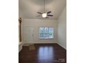 Living room with hardwood floors, high ceilings, and a ceiling fan at 154 Limerick Rd # E, Mooresville, NC 28115