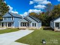 Newly built home with gray siding, brick accents, and a front porch at 606 Meadow Ave, Spencer, NC 28159