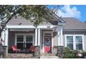 House exterior featuring a welcoming front porch and red door at 9538 Skybluff Cir, Huntersville, NC 28078