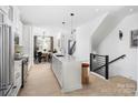 Open concept kitchen with island and view into dining area at 2051 Clarksdale Dr # 29, Charlotte, NC 28206