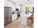Modern kitchen featuring white cabinets and a large island at 2051 Clarksdale Dr # 29, Charlotte, NC 28206