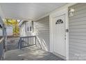 House exterior with gray siding, front porch and white door at 220 East St, Albemarle, NC 28001