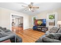 Living room with hardwood floors, couches, and a large TV at 2401 Boy Scout Rd, Lincolnton, NC 28092