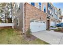 Attached two-car garage with a neutral color exterior at 303 Grove Gate Ln, Indian Trail, NC 28079