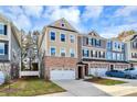 Three-story townhome with neutral exterior and a two-car garage at 303 Grove Gate Ln, Indian Trail, NC 28079