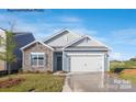 One-story home with stone and gray siding, and a two-car garage at 8039 Plymouth Dr, Sherrills Ford, NC 28673