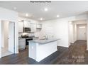 Open concept kitchen with granite island and hardwood floors at 8047 Plymouth Dr, Sherrills Ford, NC 28673