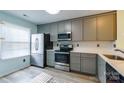 Modern kitchen with gray cabinets and quartz countertops at 992 Heritage Pkwy, Fort Mill, SC 29715