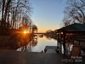 Scenic sunset view over calm lake waters from a lakeside deck at 466 Lakeview Shores Loop, Mooresville, NC 28117