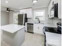 Modern kitchen with stainless steel appliances and white cabinetry at 3728 Woodleaf Rd, Charlotte, NC 28205