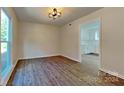 Bright dining room with hardwood floors and kitchen view at 4242 Saint Audrey Pl, Charlotte, NC 28269