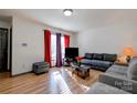 Bright living room featuring a comfortable sectional sofa and wood-look floors at 710 W Elm St, Shelby, NC 28150