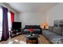 Living room with sectional sofa, coffee table, and large TV at 710 W Elm St, Shelby, NC 28150
