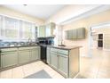 Kitchen with light green cabinets, granite counters, and stainless steel appliances at 3635 Tryon Courthouse Rd, Cherryville, NC 28021