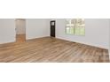 Light filled living room with light brown vinyl plank flooring at 106 Pinecrest Dr, Shelby, NC 28152