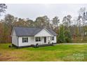 White house with dark gray roof, and a green lawn at 106 Pinecrest Dr, Shelby, NC 28152