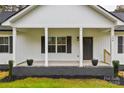 Front porch view of a charming farmhouse with gray accents at 106 Pinecrest Dr, Shelby, NC 28152