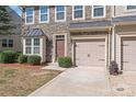 Two story townhome with stone exterior, two car garage, and landscaping at 9510 Birkwood Ct, Charlotte, NC 28278