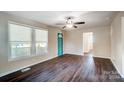 Living room with dark laminate flooring and teal door at 686 Childers St, Belmont, NC 28012