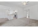 Open living room with kitchen island and carpeted floors at 3221 Maple Ridge Dr, Gastonia, NC 28052