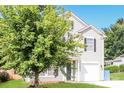 Two-story house with gray siding, a two-car garage, and a large tree in the front yard at 612 Carybrook Ct, York, SC 29745