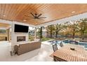 Outdoor patio with pool, seating area, fireplace and a wood covered ceiling at 1017 Maxwell Ct # 5, Marvin, NC 28173