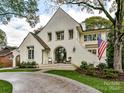 Curb appeal abounds in this charming white brick home with a circular driveway at 1401 Heather Ln, Charlotte, NC 28209