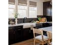 White farmhouse sink and dark cabinetry in a well-lit kitchen at 1512 Levy Way, Charlotte, NC 28205