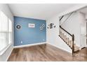 Living area with hardwood floors and an accent wall at 1707 Scarbrough Sw Cir, Concord, NC 28025