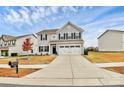 Two-story house with a two-car garage and landscaping at 1707 Scarbrough Sw Cir, Concord, NC 28025