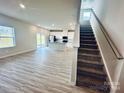 Open-concept living space with LVP flooring and kitchen access at 2107 Morgan Hills Dr, Albemarle, NC 28001